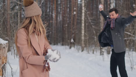 Young-couple-playing-outdoors.-Winter-season.